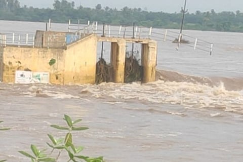 Water gushing through Enathimangalam check dam's sluice gates. Image: Maalaimalar