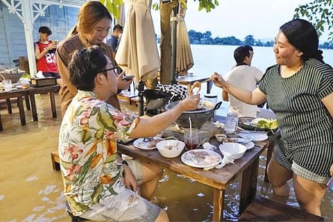 At flooded restaurant near Bangkok, the special is a splash