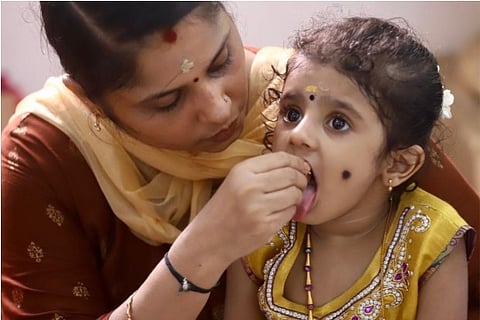 A glimpse of a mother feeding her child (Credit: Mani)