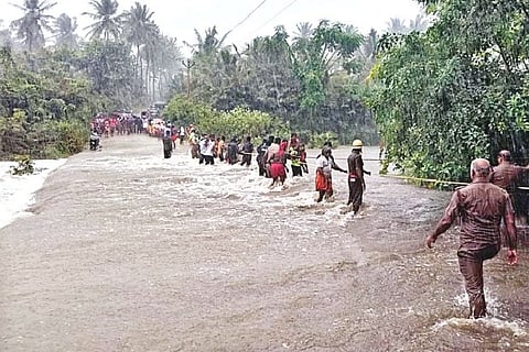 Fire and Rescue Services personnel rescuing devotees caught in flash floods at foothills of temple