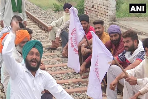 Farm Law protestors sit on railway tracks in Punjab (Photo: ANI)