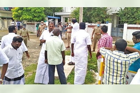 AIADMK workers wait infront of a property of C Vijaya Baskar that was raided by DVAC in Pudukkottai