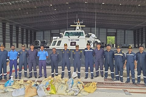 Officers with the seized sea cucumber.