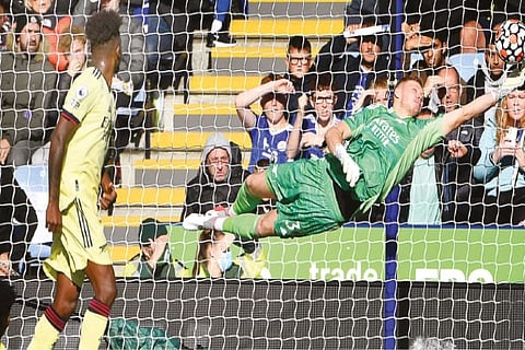 Arsenal goalkeeper Aaron Ramsdale saves a Leicester City free-kick