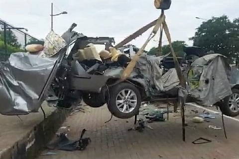 Mangled remains of the car being towed away on Sunday morning.