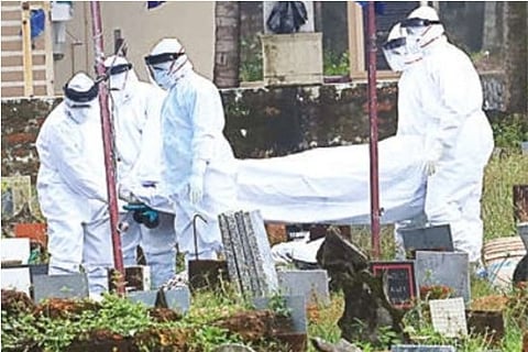 Health workers bury the boy?s body on Sunday