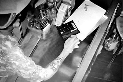 CCTV footage showing tattoo of skull on forearm of one of the burglars