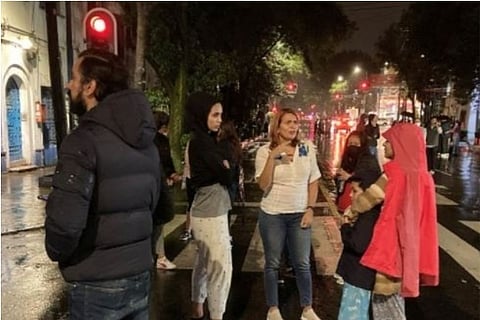 People came out of buildings after an earthquake shook the apartments (Credit: Reuters)
