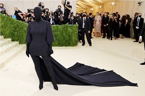 Kim Kardashian, wearing Balenciaga, covering even her face entirely in black