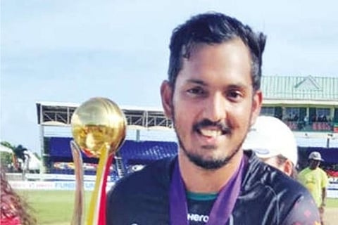 Malolan Rangarajan poses with the trophy