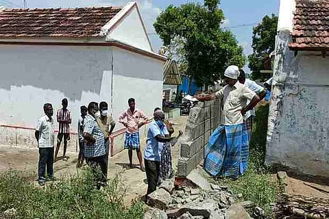 An encroached wall blocking access to a Dalit colony is being demolished in Namakkal