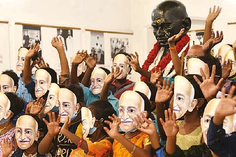 Children pay homage by wearing Gandhiji?s masks at Khadi Bhavan in Madurai on Wednesday.