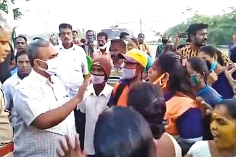 Commuters arguing with officials over the issue