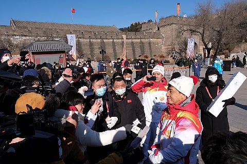 Actor Jackie Chan talks to the media after taking part in the Torch Relay (Reuters)