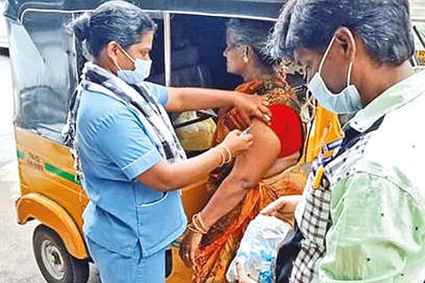 A commuter in an auto gets the jab during the mega drive on Saturday.