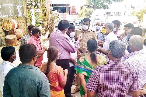 Officials holding talks with residents in Karamadai near Coimbatore on Tuesday