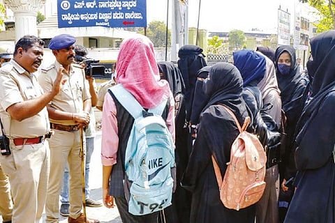 Muslim students talk to police after they were asked to take off their hijab before entering college campus
