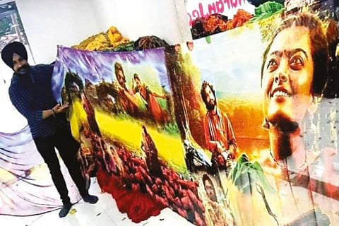 Charanpal Singh holds a Pushpa saree