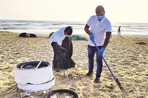 Staff of the hotel join hands in cleaning the beach