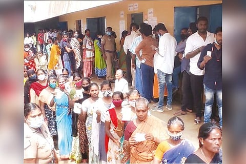 Voters waiting in long queues in a polling booth at Tiruparankundram