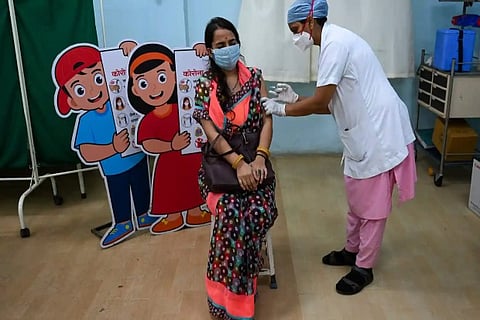A woman gets inoculated with a dose of Covishield vaccine (Credit: AFP)