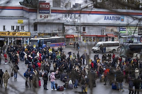 People try to get onto buses to leave Kyiv, Ukraine (Image credit: AP)