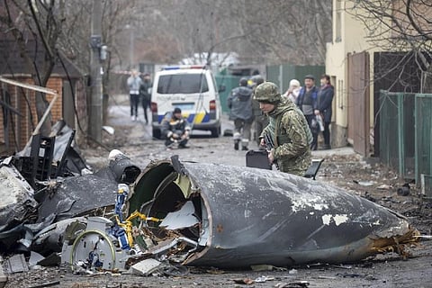 An Ukrainian army soldier inspects fragments of a downed aircraft in Kyiv (Image credit: AP)