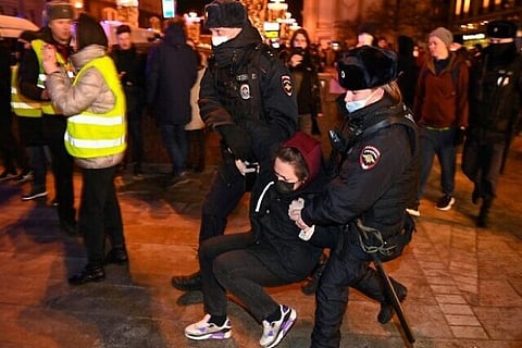 Police officers detain a woman during the protest (Image Courtesy: AFP)