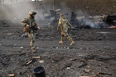 Ukrainian service members at the russian raided site in Kyiv (AFP)