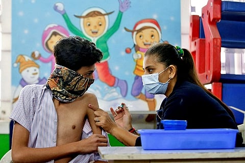 A boy receives a dose of Covaxin in Ahmedabad (Credit: Reuters)