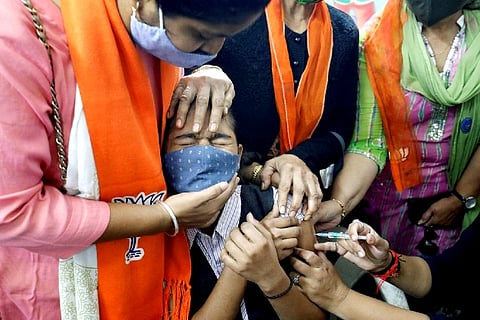 A girl reacts as she receives a Covid dose (Credit: Reuters)