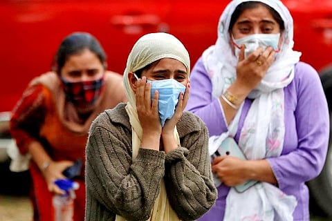 Relatives of a man who died from the coronavirus disease (Credit: Reuters)