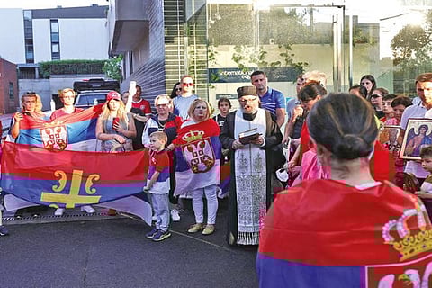 Supporters of Novak Djokovic gather for a prayer outside the detention centre