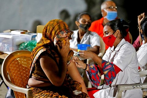 A health worker administer covid vaccine (Credit: Reuters)