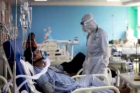 A doctor wearing (PPE) suit looks after a Covid patient at the Intensive Care Unit (Credit: AFP)