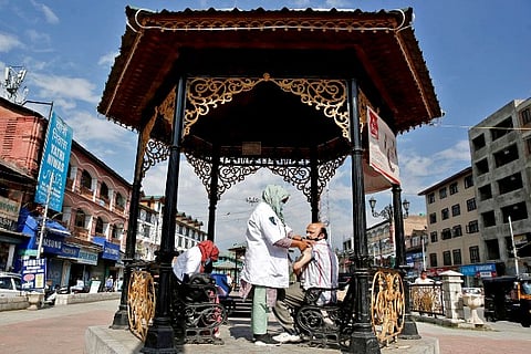A man taking Covid vaccine from a health care worker (Credit: Reuters)