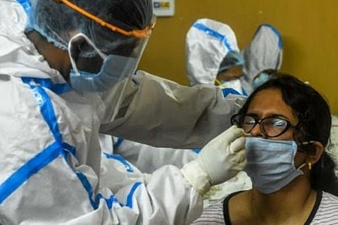 A health worker taking a swab sample (Image credit: PTI)