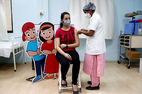 A woman receives a Covid vaccine (Credit: Reuters)