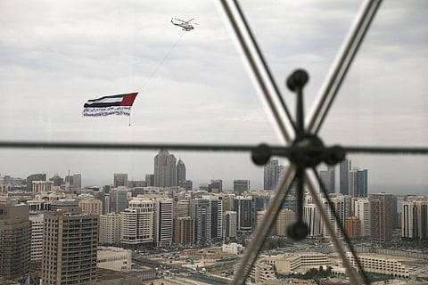 A helicopter flies over the downtown skyline (Credit: Reuters)
