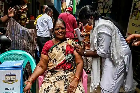 A health worker inoculates a beneficiary with the dose of the Covid-19 vaccine (Credit: Reuters)
