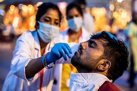 A healthworker taking swag for Covid testing (Credit: AFP)