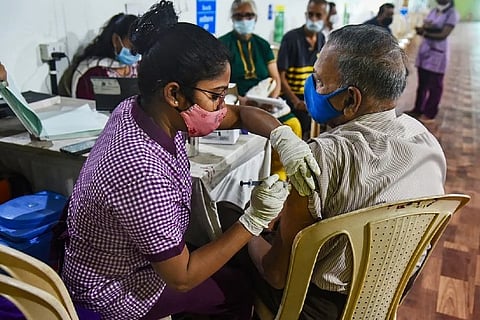 A healthcare worker gives a Covid jab (Image credit: PTI)