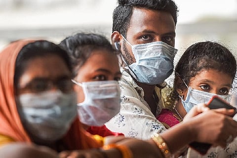 Passengers wear protective masks, in wake of the deadly novel coronavirus (Credit: PTI)