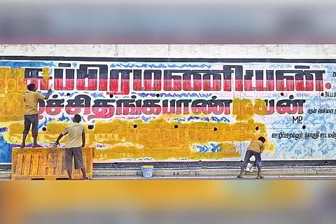 Workers erasing political graffiti ahead of the urban civic polls, in Chennai on Thursday