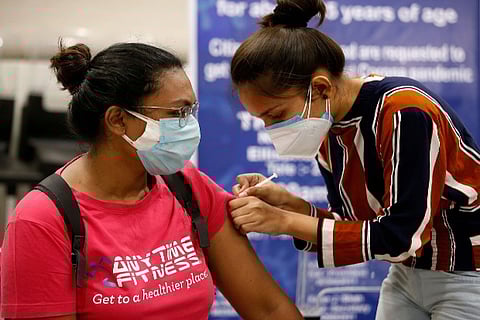 A woman receives a Covid vaccine (Credit: Reuters)