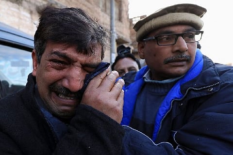 Relative of the slain priest in tears.