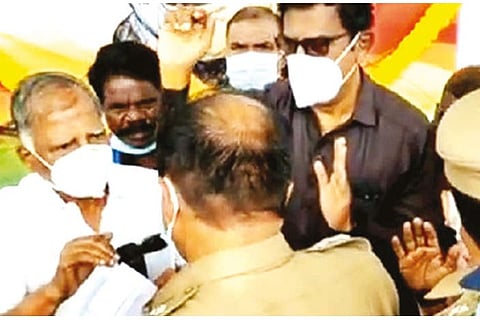 Police stopping CPM politburo member G Ramakrishnan from taking a pledge in Coimbatore on Sunday