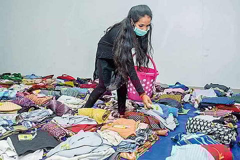 A volunteer going through collected clothes (Photo: Justin George)