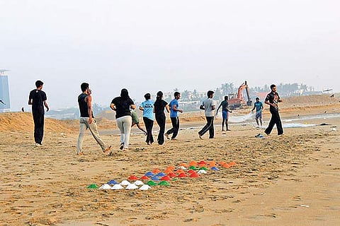Fitness enthusiasts at a workout session at a city beach