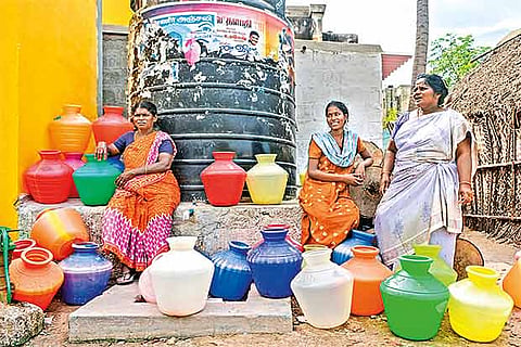 Women wait for the Merto Water tanker to fill buckets with drinking water (Photo: Justin George)